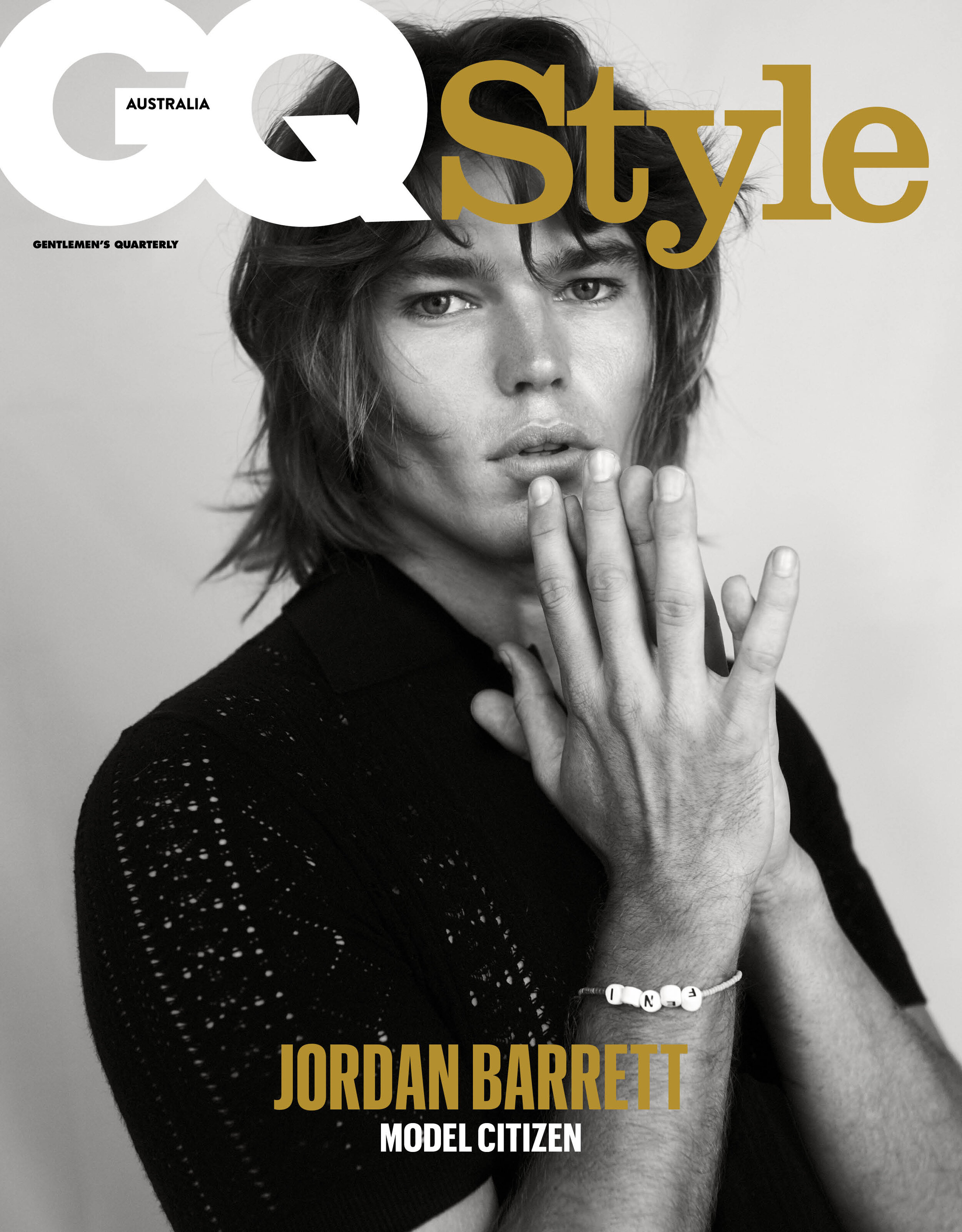GQ Style cover featuring Jordan Barrett in a close-up studio portrait, wearing a black textured shirt and beaded bracelet against a neutral background.